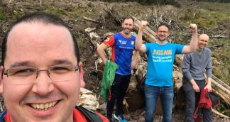 group of fundraisers in nature one wearing a jigsaw blue tshirt