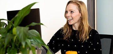 senior clinician at her computer smiling