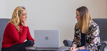 clincian and community working sitting talking about work