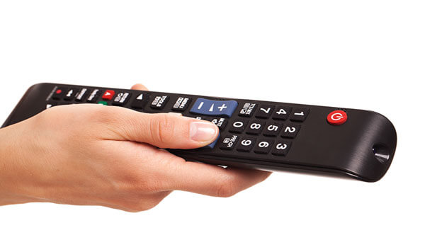 Image of woman holding a tv remote control