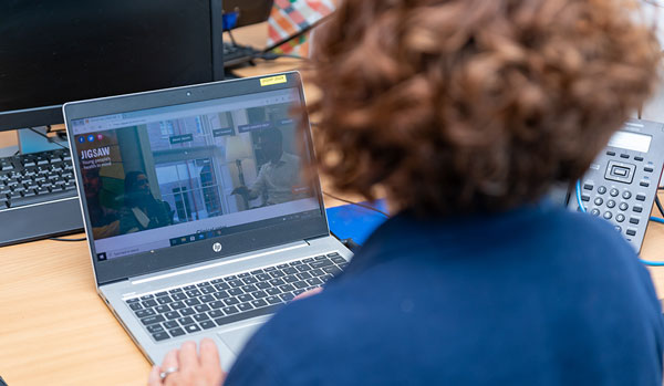 Woman sitting in front of laptop in an office