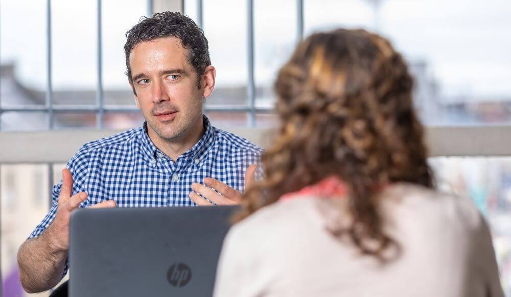 Male clinician chats to client