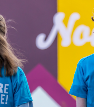 2 young people wearing you are awesome tshirts from behind close up
