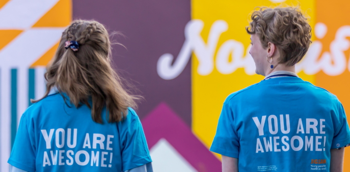 2 young people wearing you are awesome tshirts from behind close up