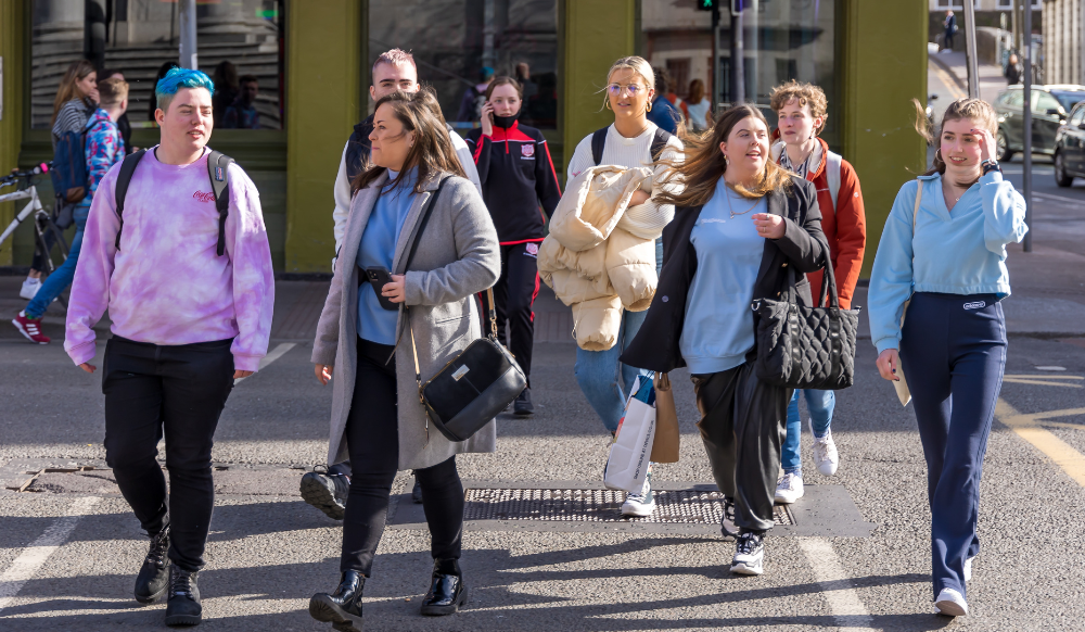 group of young people crossing a road