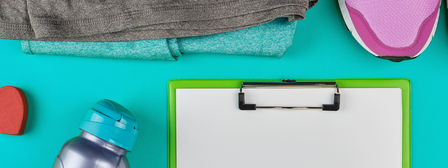Girl wearing helmet brushing white horse