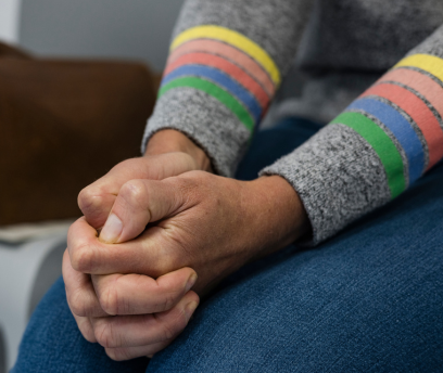 Shot of a unrecognizable young person sitting on a sofa and feeling anxious (408 x 344 px)