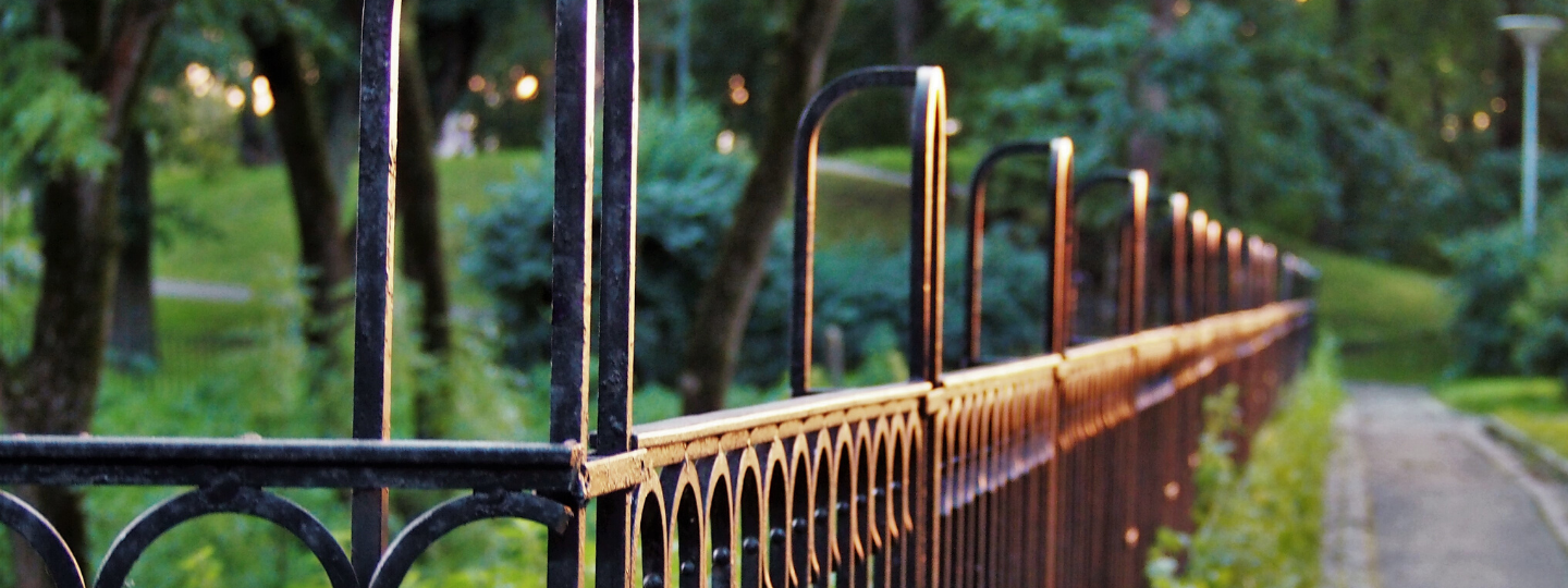 Two young people, girl and boy sitting down laughing on a grey couch