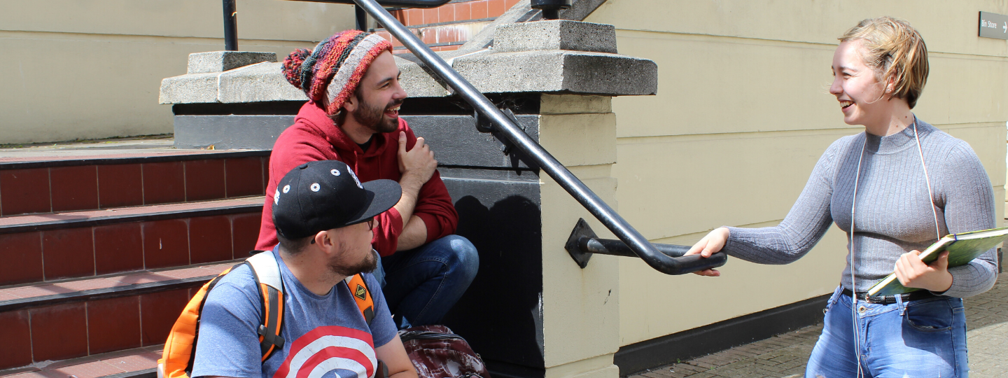 close up of hands resting on clipboard on lap holding notepaper